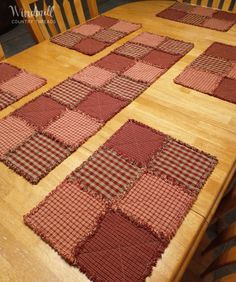 the table is covered with red and white checkered placemats on wooden chairs