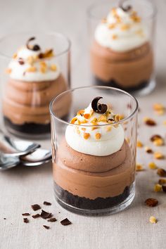 two desserts in small glasses on a table