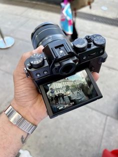 a person holding up a camera to take a photo