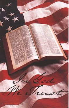 an open book sitting on top of an american flag with the words god, he must be loved