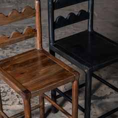 two wooden chairs sitting next to each other