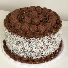 a chocolate cake with white and brown frosting