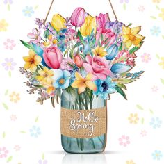 a glass jar filled with colorful flowers on top of a white table next to floral wallpaper