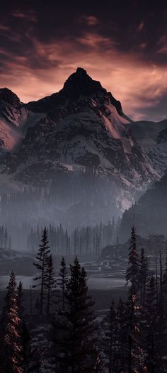 the mountains are covered in snow and trees at night, as the sun is setting