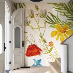 an entry way with flowers painted on the wall