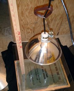 a lamp that is sitting on top of a table next to a measuring tape and ruler