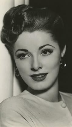 an old black and white photo of a woman