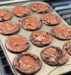 chocolate cookies are sitting on top of an oven tray with melted brownie toppings