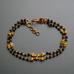 "Layered gold chain bracelet with black beads and gold balls, handcrafted with love and care, this is a very comfortable bracelet. A perfect accessory for everyday wear. Lightweight and stylish..! Available in single strand or double strand. * Length : 5.5\" to 9\" + 0.5\" extender eg : 6\" length will fit wrist size of 6\"- 6.5\" * Gold : 18k Solid Yellow Gold * Gold Weight - 4.5 gms approx for 6\" inches double strand with extender - For longer/shorter length, please ask for a quote before pla Black Bracelet With Gold Beads, Black Beaded Chain Bracelet For Gift, Black Beaded Bracelets With Gold Beads For Gifts, Black Beaded Bracelet As Gift, Gift Black Beaded Chain Bracelet, Gold Bracelet Jewelry With Black Beads, Gold Bracelet With Black Beads Jewelry, Yellow Gold Bracelets With Black Beads As Gift, Yellow Gold Bracelets With Black Beads For Gift