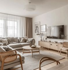 a living room filled with furniture and a flat screen tv on top of a wooden table