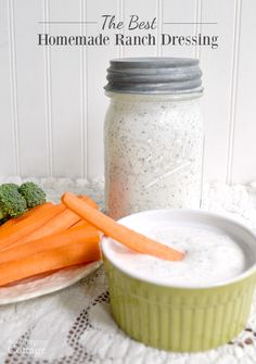 carrots and broccoli on a plate next to a jar of ranch dressing