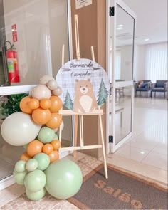 there is a bear sign and balloons in the room