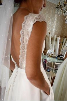 the back of a bride's wedding dress is seen in this instagramtion