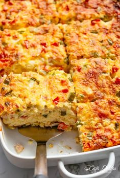 a casserole with cheese and vegetables in a white dish