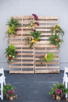 a wooden pallet with flowers on it and the words for a low budget construction - challenged wedding backdrop