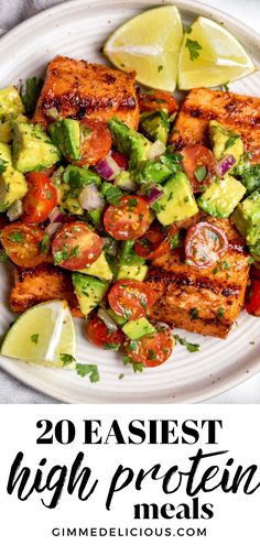 a white plate topped with tofu and avocado next to lime wedges