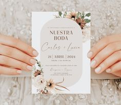 two hands holding up a wedding card