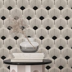 a black and white wallpaper with an art deco style design on the side table