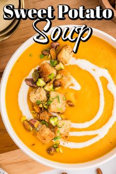 sweet potato soup with croutons and pistachios in a white bowl