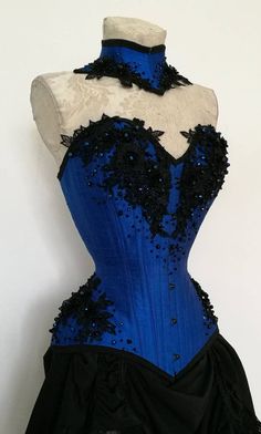 Overbust corset and neck corset made or royal blue raw silk with handsewn 3D floral lace and glass blue and black glass beads. Can be ordered in any other shade/color with several options for lace applications. All the details are carefully sewn on the corset that has 3 layers of fabric and 18 steel bones and a steel front busk. Luxury Blue Corset With Corset Back, Luxury Blue Gown With Corset Back, Luxury Blue Bustier Corset, Luxury Blue Corset Dress For Evening, Luxury Blue Fitted Bodice Corset, Luxury Blue Fitted Corset, Luxury Overbust Bodice For Prom, Luxury Blue Elegant Corset, Luxury Blue Corset