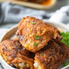 some fried food on a white plate with parsley