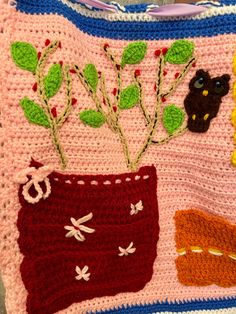 a crocheted bag with flowers and animals on it