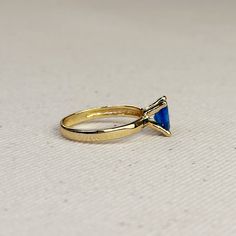 Discover elegance and timelessness with our 18k Gold Filled Royal Blue Solitaire Ring. Crafted with precision and detail, this ring exudes a regal allure that will elevate any outfit. A must-have for those who appreciate luxury and sophistication. Metal: 18k Gold filled Available sizes: 5.5, 6,7, 8, and 9 Hypoallergenic Water-resistant Handcrafted in Brazil Yellow Gold Rings With Blue Topaz For Formal Occasions, Classic Blue Oval Opal Ring, Elegant Tanzanite Diamond Cut Ring, Formal Yellow Gold Rings With Blue Topaz, Elegant Gold Rings With Tanzanite, Formal Yellow Gold Ring With Blue Topaz, Elegant Gold Tanzanite Rings, Classic Royal Blue Round Sapphire Ring, Elegant Tanzanite Birthstone Ring For Promise