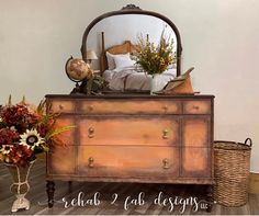 an old dresser is decorated with flowers and plants