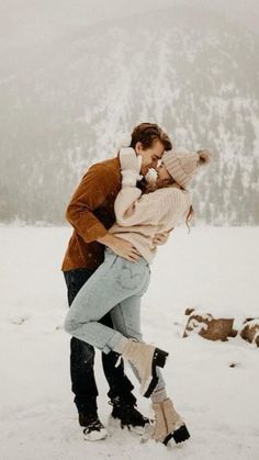 a man and woman kissing in the snow