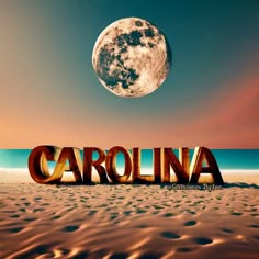 the word carolina written in metal letters on a sandy beach under a full moon