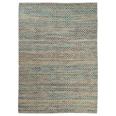 an area rug with various colors and patterns on the floor, including blue, green, beige