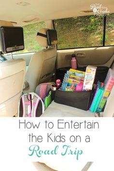 the back seat of a car filled with toys and other items that includes books, magazines