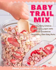 baby trail mix in a glass jar with strawberries and strawberrys on the side