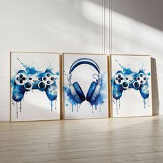 three blue and white paintings with headphones on them