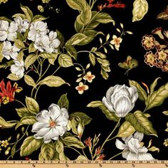 a black background with white flowers and green leaves on the bottom right corner is a ruler