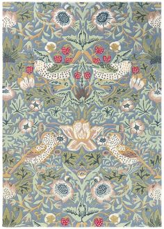 an intricately designed rug with birds and flowers