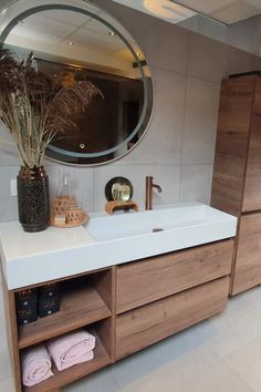 a bathroom with a sink, mirror and towel rack