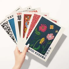 a person holding four different types of japanese art cards in their hands, with the words yay written on them