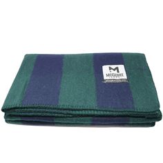 a green and blue blanket with the m logo on it's front end, folded up