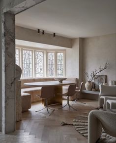 a living room filled with furniture next to a window covered in frosted glass windows