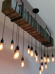 a bunch of light bulbs hanging from a wooden beam