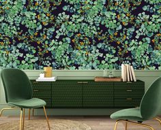 two green chairs are in front of a wallpapered with blue and yellow flowers