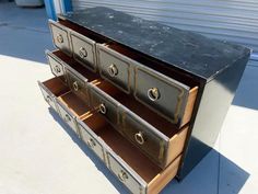 an old dresser with metal drawers on it