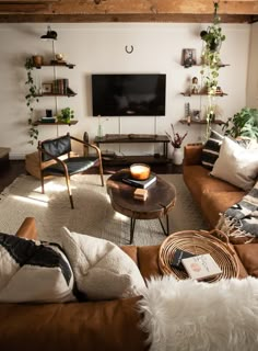 a living room filled with furniture and a flat screen tv mounted to the side of a wall