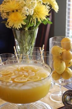 the lemonade drink is in a glass bowl