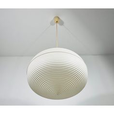 a white circular light hanging from a ceiling