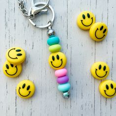 several smiley face beads are attached to a keychain