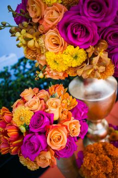 an arrangement of flowers in a vase on a table