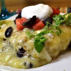 an enchilada with sour cream and black olives