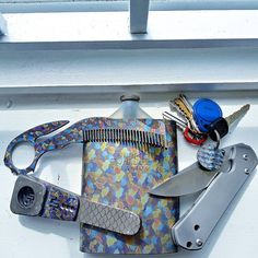 scissors, combs and other assorted items are sitting on the window sill